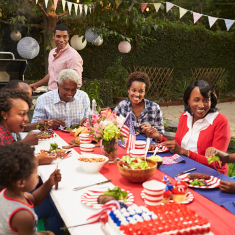 Multi generation black family at table for 4th July barbecue